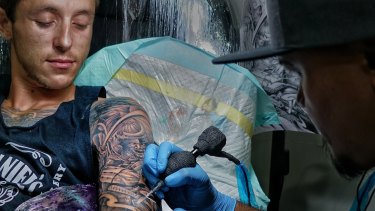 Jayden McDermott and his tattoo artist Iwan Speank working on a full sleeve design at Celebrity Ink Tattoo Bali studio.