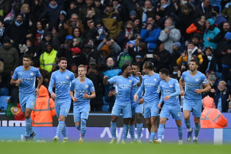Raheem Sterling and his City teammates celebrate his goal.