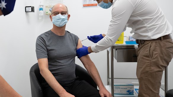Vaccination style: Chief Medical Officer Paul Kelly receives a dose of the Pfizer vaccine on Sunday.