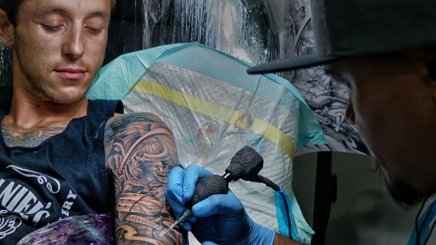 Jayden McDermott and his tattoo artist Iwan Speank working on a full sleeve design at Celebrity Ink Tattoo Bali studio.