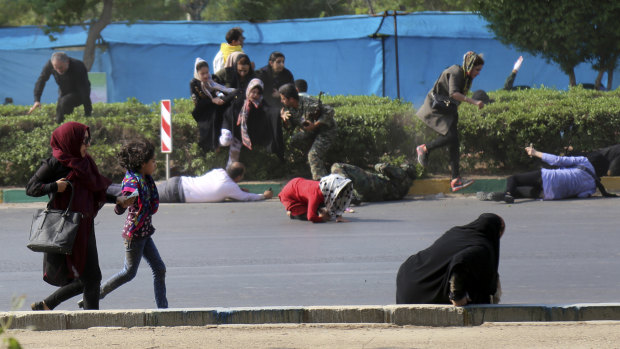 Civilians try to take shelter in a shooting scene, during a military parade marking the 38th anniversary of Iraq's 1980 invasion of Iran, in the southwestern city of Ahvaz.