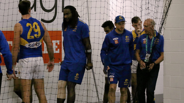 Crocked: Ruckman Nic Naitanui on crutches in the Eagles' dressing room after the game.