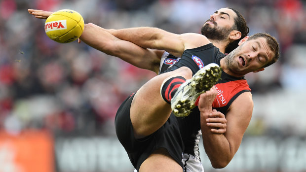 Full stretch: Collingwood's Brodie Grundy of and Tom Bellchambers locked in a tussle for possession.