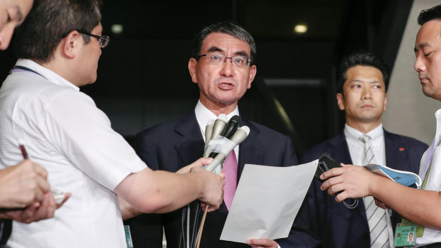 Japanese Foreign Minister Taro Kono, centre, speaks to reporters following South Korea's announcement that it will terminate an intelligence-sharing deal with Japan at the Foreign Ministry in Tokyo.