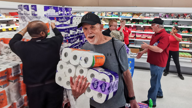People receiving toilet paper, paper towel and pasta at Coles.