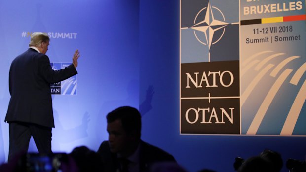 Donald Trump leaves after a press conference at the end of the NATO summit in Brussels.