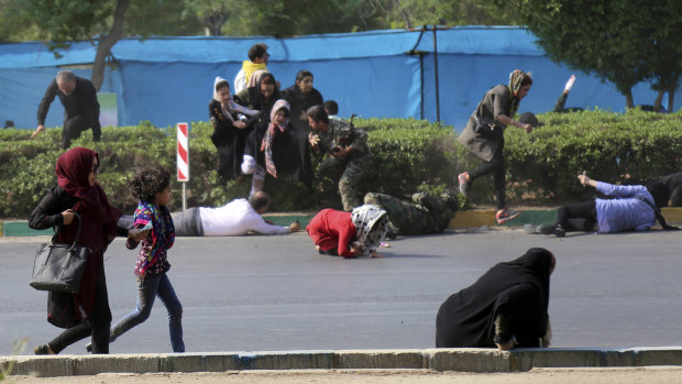 Civilians try to take shelter in a shooting scene, during a military parade marking the 38th anniversary of Iraq's 1980 invasion of Iran, in the southwestern city of Ahvaz.