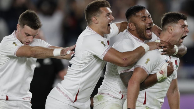 Dominant: England celebrate their upset over New Zealand at International Yokohama Stadium.