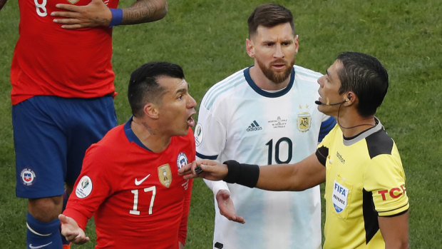 Payback?: Chile's Gary Medel, left, and Argentina's Lionel Messi, protest to referee Mario Diaz after both of them received red cards during the Copa America third-place match.