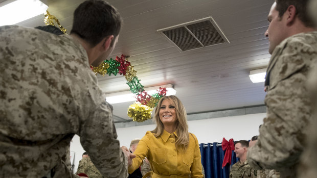 First lady Melania Trump talks with troops at a dining hall.