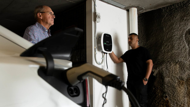 Apartment owner Brian Jackson, left, with building manager Kay Pirzad, have been instrumental in getting charging stations for electric vehicles into their apartment building for residents. 
