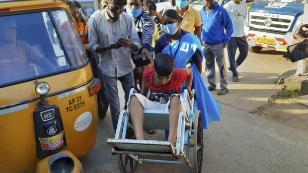 A young patient is brought in a wheelchair to the district government hospital in Eluru.