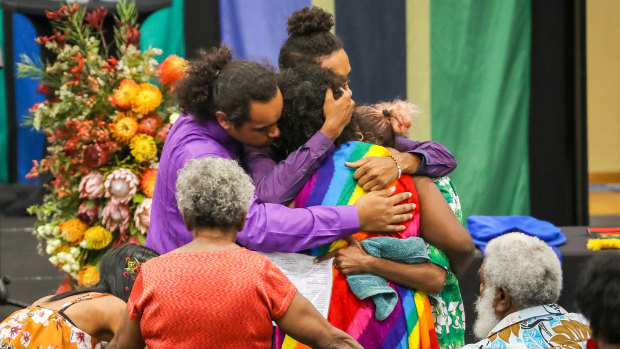 Mabo family members comfort each other during the state funeral held for Dr Ernestine 'Bonita' Mabo AO at Townsville Stadium.