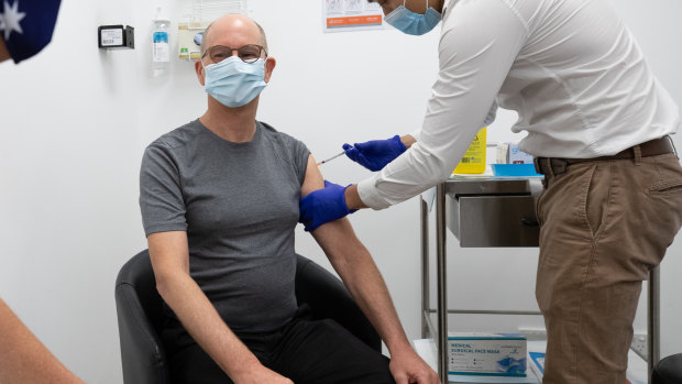 Vaccination style: Chief Medical Officer Paul Kelly receives a dose of the Pfizer vaccine on Sunday.