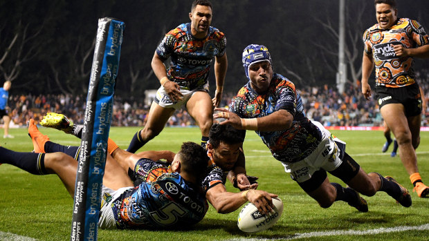 David Nofoaluma overcomes some desperation Cowboys defence for an early Tigers try.