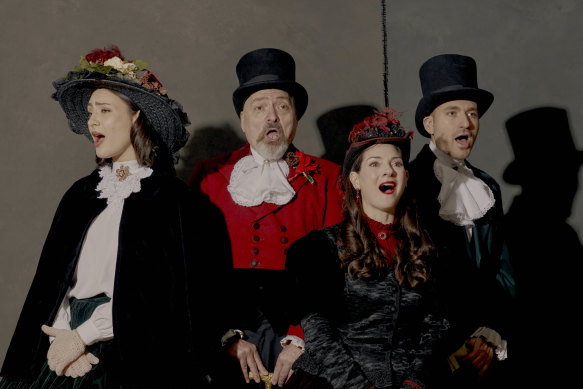 Dickens Victorian Carolers, from left: Bretana Turkon, Tom Andolora, Rebecca Reres and Justin Tepper in 19th-century garb, in Manhattan, Dec. 22, 2022. Andolora, leader of the caroling group since he founded it in 1982, is calling it quits, and worries for the survival of carolling in New York.