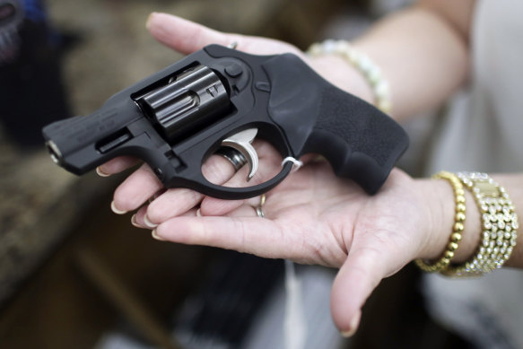 Haylee Romander shows off her new .357 magnum pistol at Ross Coin and Gun, in Idaho Falls, last month. Romander says she drives to Utah a lot and on a recent trip her car broke down late at night making her nervous. "Hopefully I'll never have to use it but I'll be ok if something bad does happen," said Romander.  