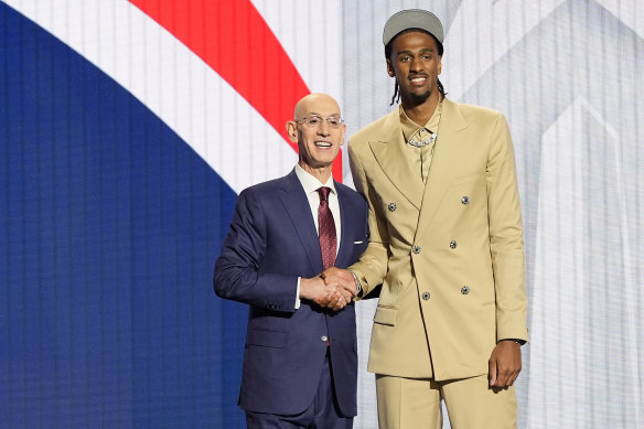 NBL Next Star Alex Sarr, right, poses with NBA commissioner Adam Silver after being drafted by the Washington Wizards.