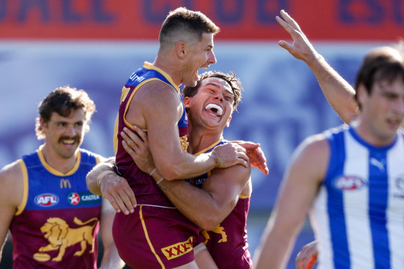 Dayne Zorko of the Lions celebrates a goal with teammates.