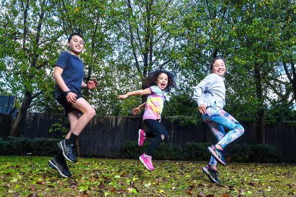 Alex, Hattie and Georgie Gurvich doing their regular backyard exercises. Georgie misses sports and is training for cross country by running with her dad. 