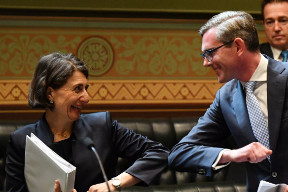 In control ... Premier Gladys Berejiklian bumps elbows with Treasurer Dominic Perrottet after he delivers the budget.