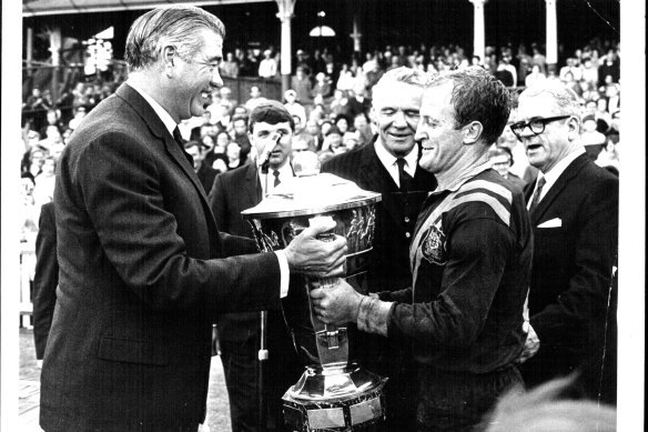 Former NSW governor Sir Roden Cutler presents the World Cup to Australia’s captain Johnny Raper in 1968. 