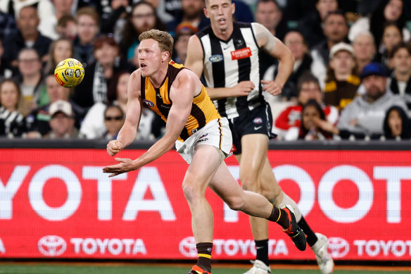 James Sicily of Hawthorn handballs.