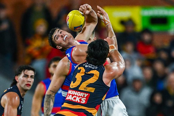 James O’Donnell of the Bulldogs over Darcy Fogarty of the Crows.