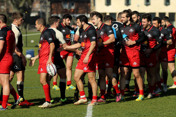 Georgia and England players shake hands after the heated training session in Oxford in 2019.