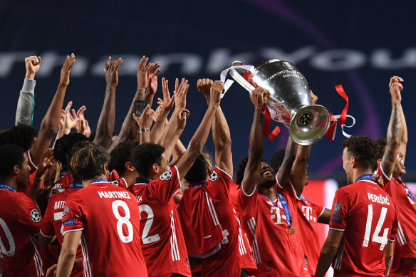 Coman lifts the Champions League trophy with his Bayern teammates.