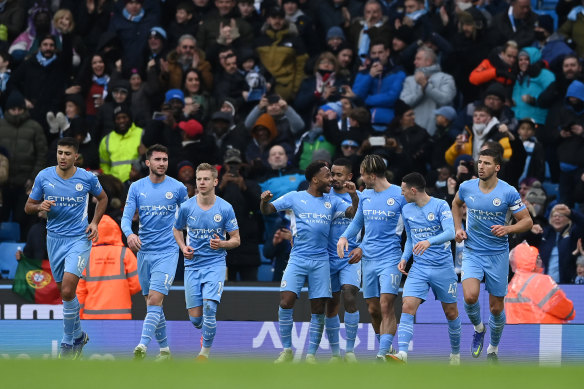 Raheem Sterling and his City teammates celebrate his goal.