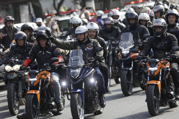 Brazil’s President Jair Bolsonaro waves during the rally of cycle enthusiasts in Sao Paulo.