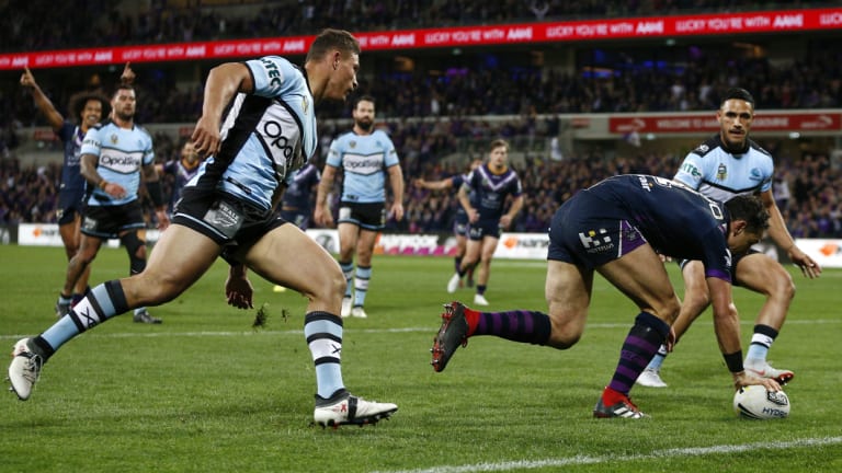 Slick: Billy Slater scores one of his two tries against an undermanned Sharks.
