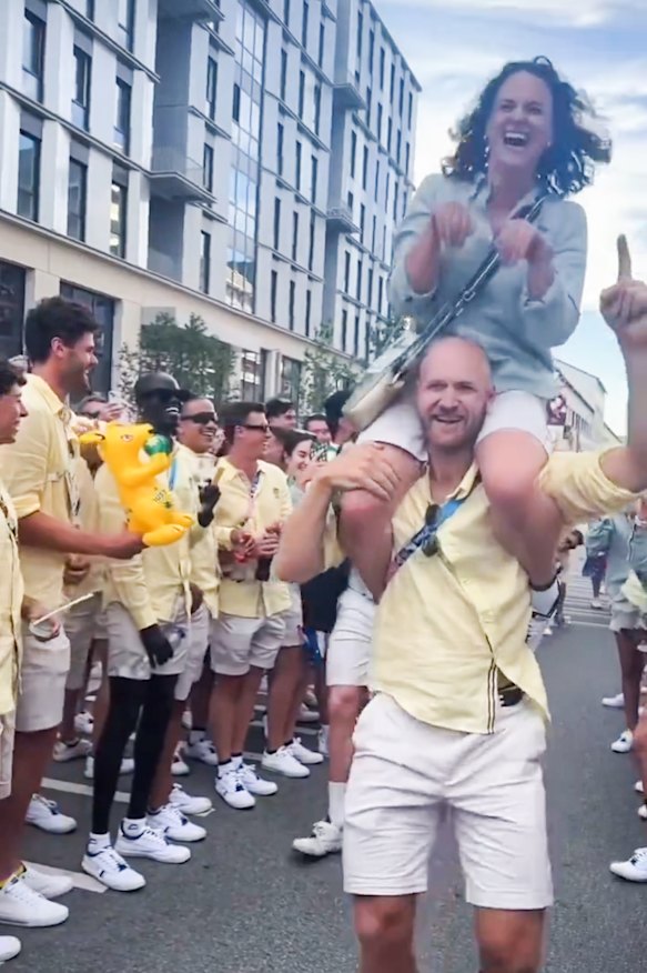 Rower Angus Widdicombe carries Raygun at the closing ceremony.