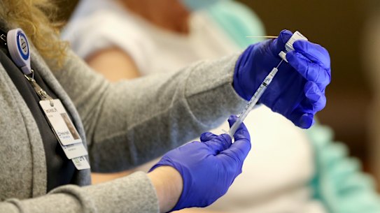 The administering of a COVID-19 vaccine.