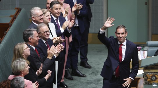 Treasurer Dr Jim Chalmers is applauded by colleagues after delivering the Budget speech.
