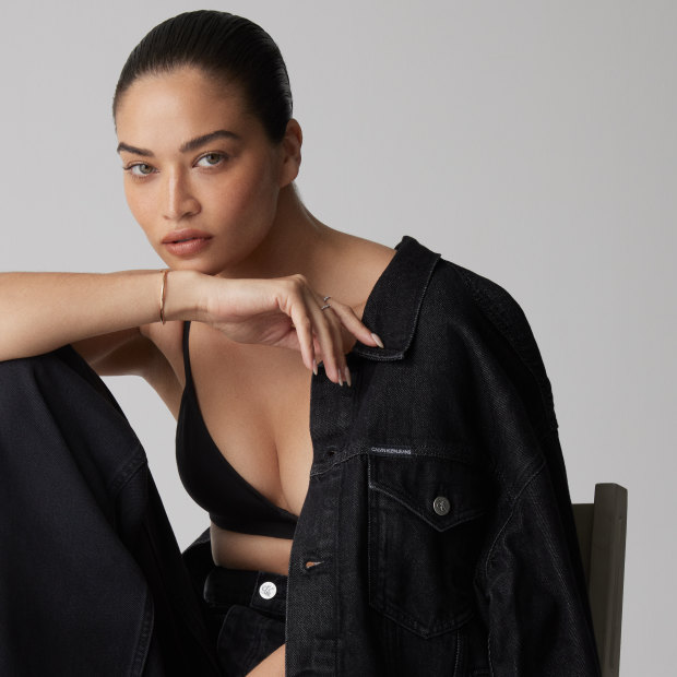 Shanina wears Calvin Klein jacket, $199, and jeans, $199, Coach bralette, $199.