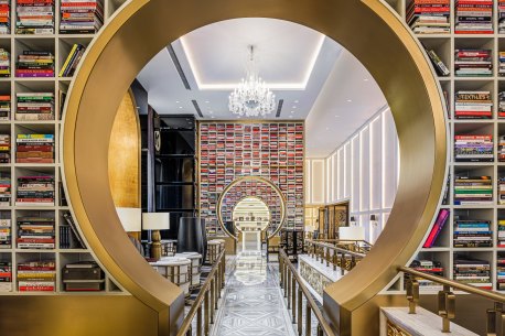 A book lounge features striking custom shelving stacked with 4000 hand-picked books.