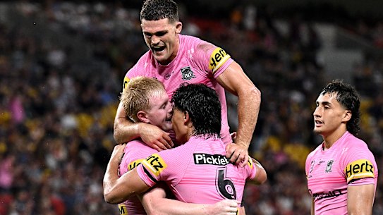 Penrith celebrate a try against Brisbane.