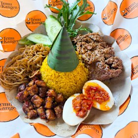 Nasi Kuning Rendang Sapi at Temu Kangen is a tower of turmeric rice served with eggs, fried tempeh, rice noodles and beef rendang.
