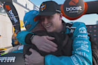 Zach Bates embraces his father, Rick, after securing pole position.