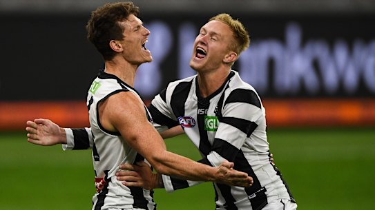 Brody Mihocek and Jaidyn Stephenson celebrates a goal late in Collingwood's win over West Coast.