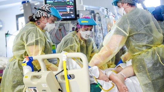 ICU physiotherapists move a coronavirus patient onto their stomach. 