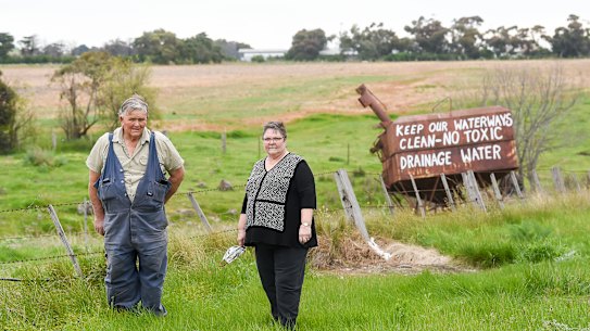 John McKenzie and sister Heather Dodd in front of the protest signs against the dumping of toxic soil from the West Gate Tunnel in Bulla.