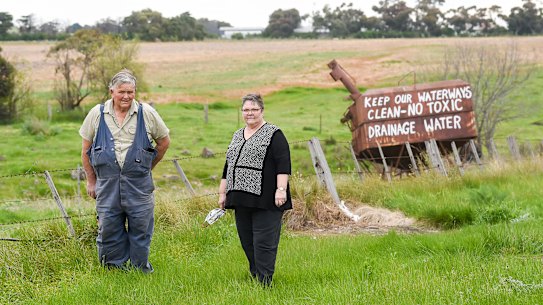 John McKenzie and sister Heather Dodd in front of the protest signs against the dumping of toxic soil from the West Gate Tunnel in Bulla.