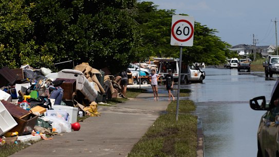 Piles of flood ruined belongings line the streets in Ballina, where residents are now eligible for disaster payments.