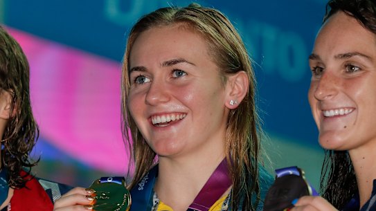 Australian gold medallist Ariarne Titmus, centre, stands with silver medallist United States' Katie Ledecky and her compatriot and bronze medallist Leah Smith after the 400m freestyle final at the World Swimming Championships in Gwangju.