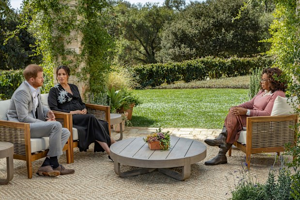 This image provided by Harpo Productions shows Prince Harry, from left, and Meghan, The Duchess of Sussex, in conversation with Oprah Winfrey. (Joe Pugliese/Harpo Productions via AP)