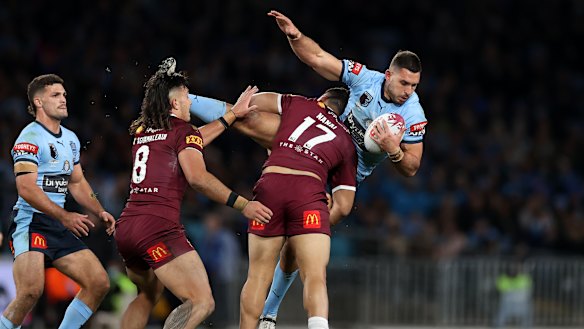 Ryan Matterson is tackled by Jeremiah Nanai. 