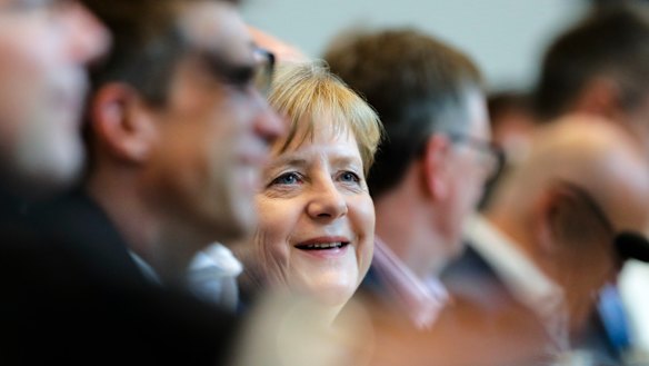 German Chancellor Angela Merkel smiles as she attends a faction meeting of the Christian Union parties, the Christian Democratic Union, CDU, and Bavarian's Christian Social Union, at the Reichstag building in Berlin, on Monday.